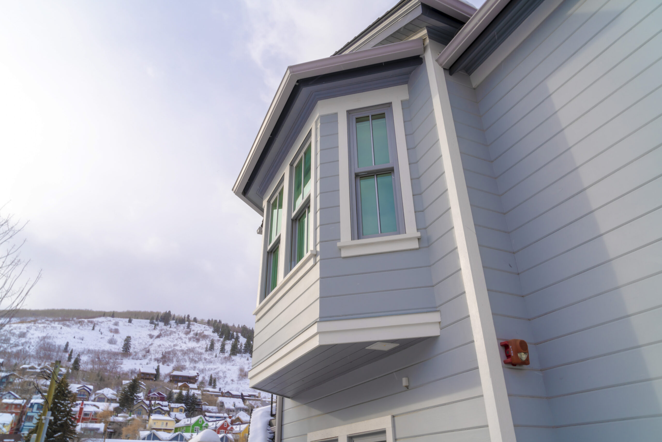 Home exterior in Park City Utah with bay window and gray horizontal wall siding